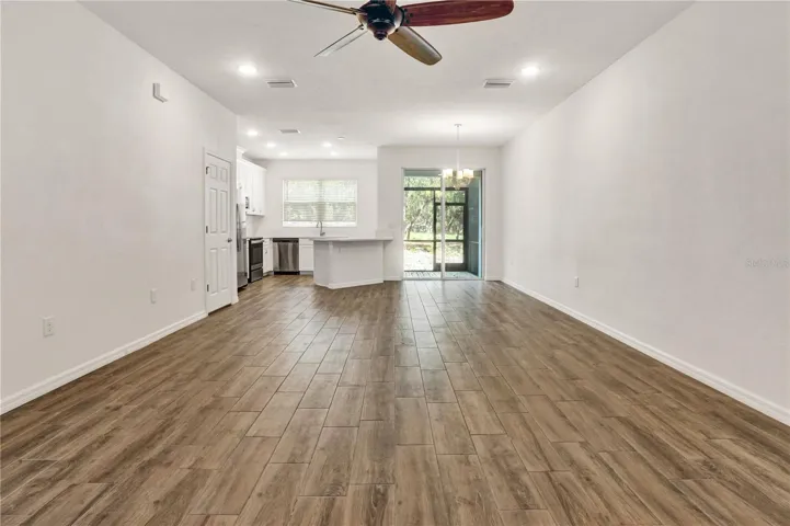 Naturally Lit Living, tall ceilings and recessed lighting throughout