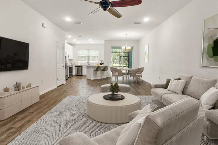 Naturally Lit Living, tall ceilings and recessed lighting throughout
