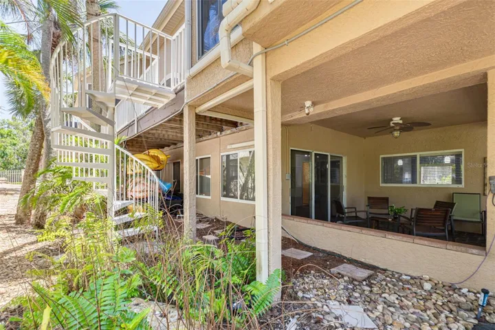 Spiral stairs from elevated deck to lower level patio
