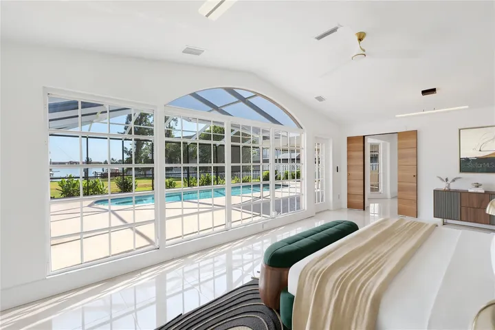 Main bedroom furnished with views to pool and Bay