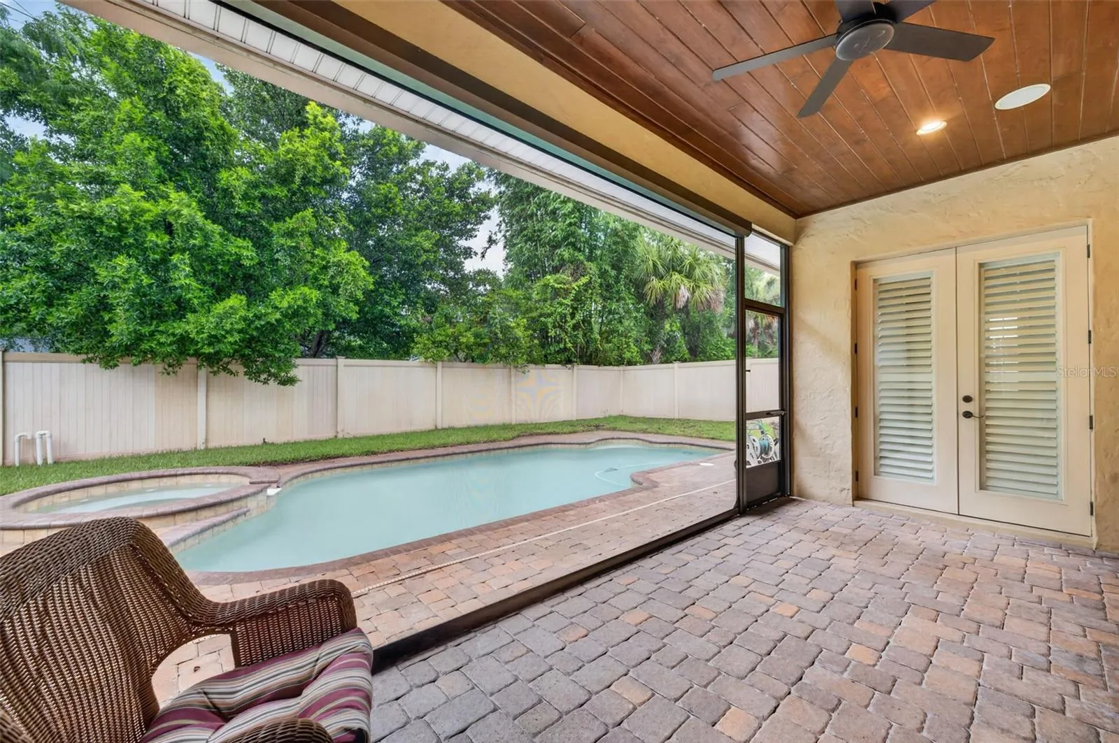 Private lanai with tongue & groove ceiling and remote screens