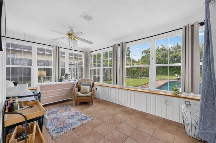 This sunroom is a great place to catch up on some reading or just relaxing overlooking the gorgeous pool.