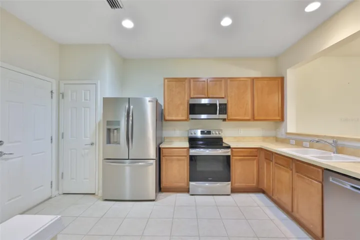 Door to garage, pantry, recessed lights overhead for a nice bright kitchen!