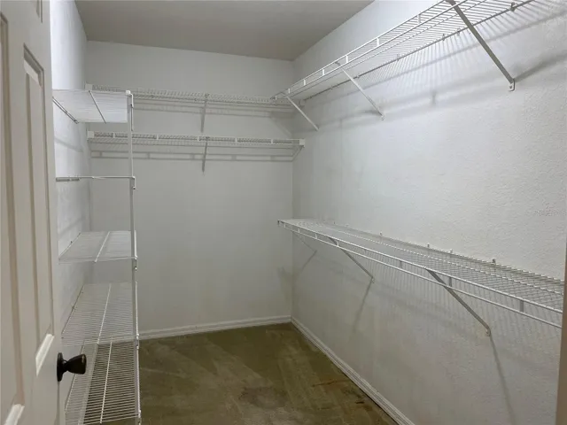 Primary bedroom walk in closet