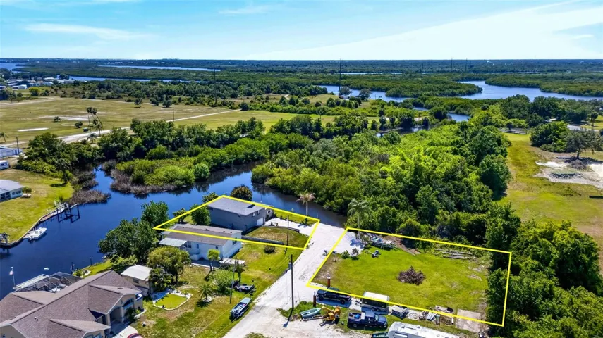 western aerial view of property home offered to left and available lots to right