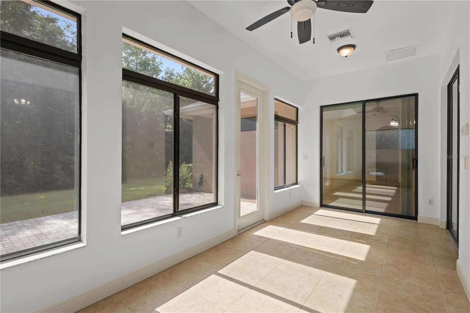 Florida room in back of home provides stunning conservation views with central AC