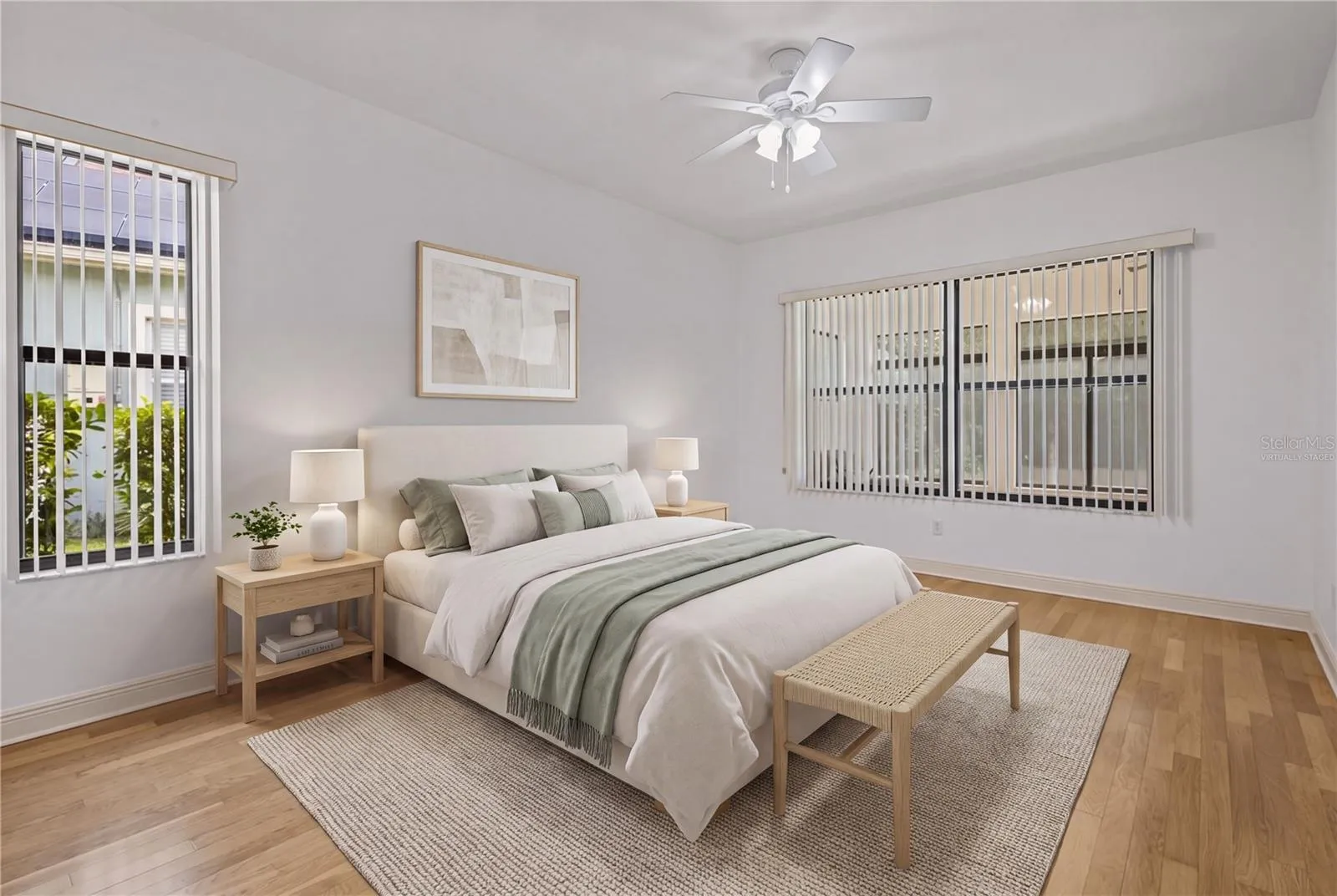 The spacious primary bedroom provides a peaceful retreat en suite bathroom. - virtually staged