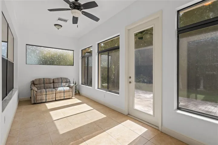 Florida room in back of home provides stunning conservation views with central AC