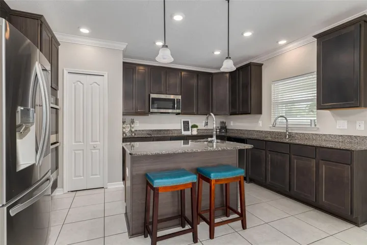 Large Island with seating, cabinets and produce sink.