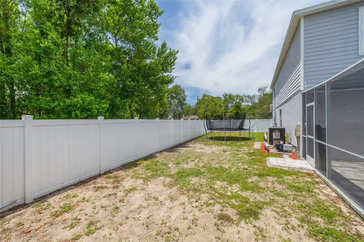The fully fenced backyard provides privacy and convenience with gates on both sides, including a double gate for easy access.