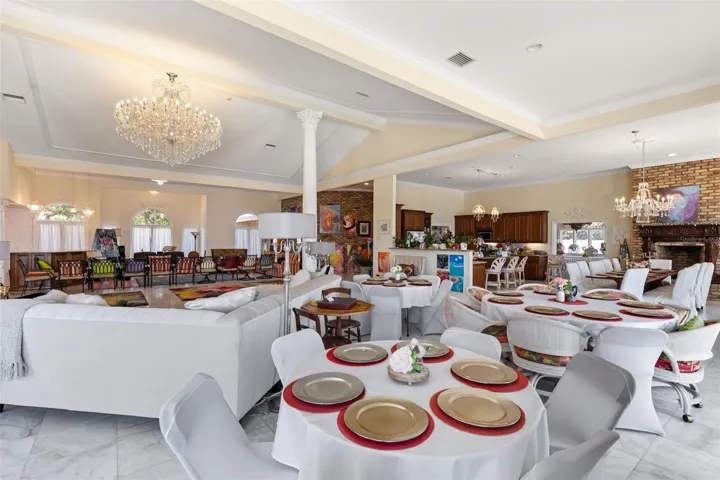 Grand living room flows effortlessly into the open floor plan, showcasing the home's scale and architecture elegance ideal for both entertaining and luxury living.