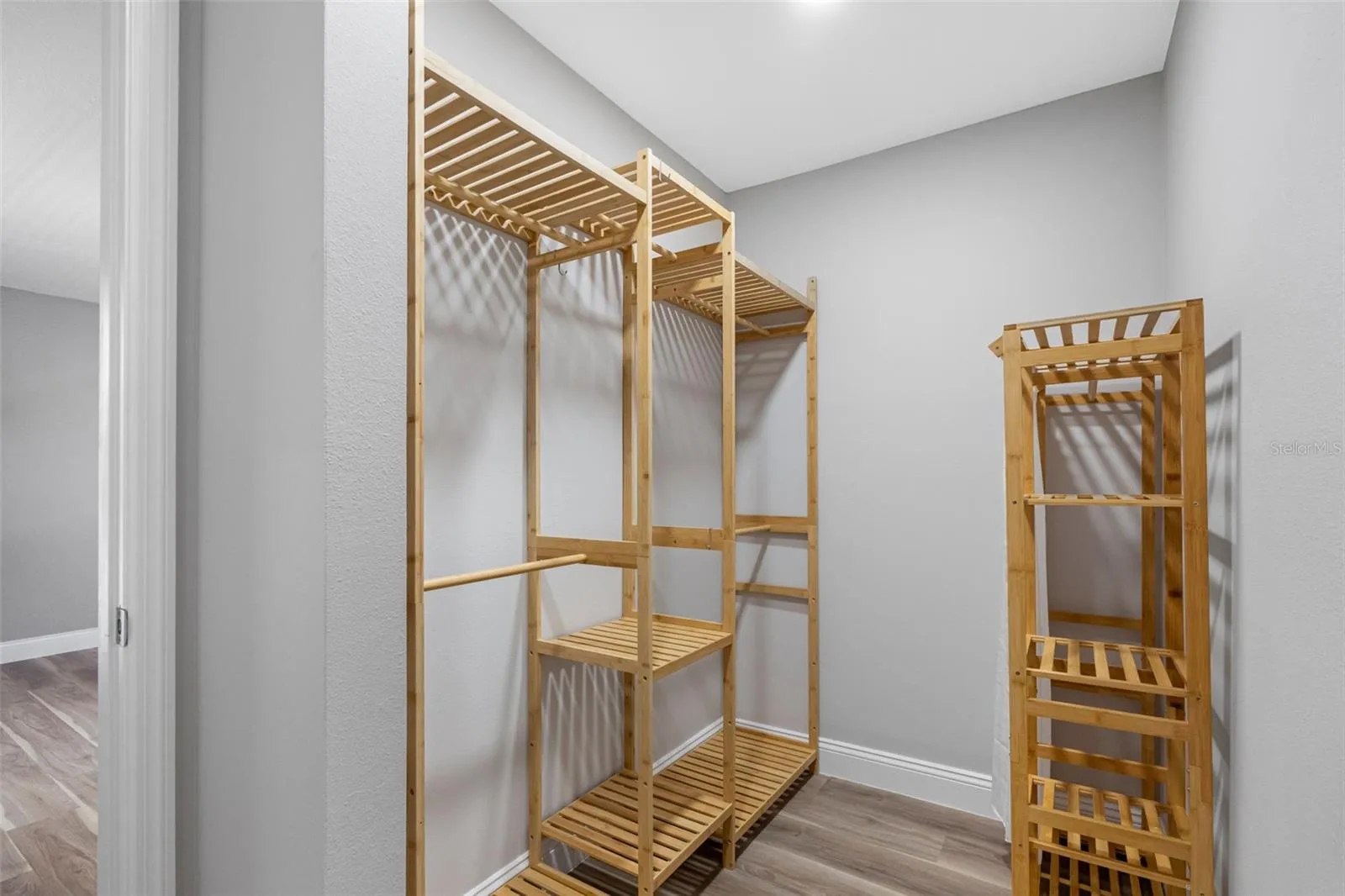 PRIMARY BEDROOM WALK-IN CLOSET WITH CUSTOM BAMBOO SHELVING