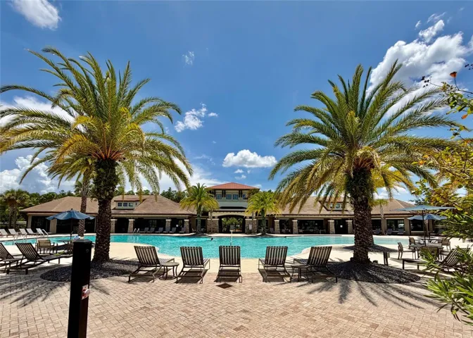 Tapestry Resort-Style Community Pool with tropical landscape, lounge chairs and cabanas