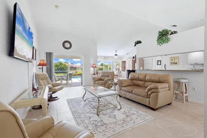 Open Floor Plan, L/R, Kitchen on right &amp; Family Room in background. Sliding Glass Doors that open to Lanai &amp; Heated Pool.