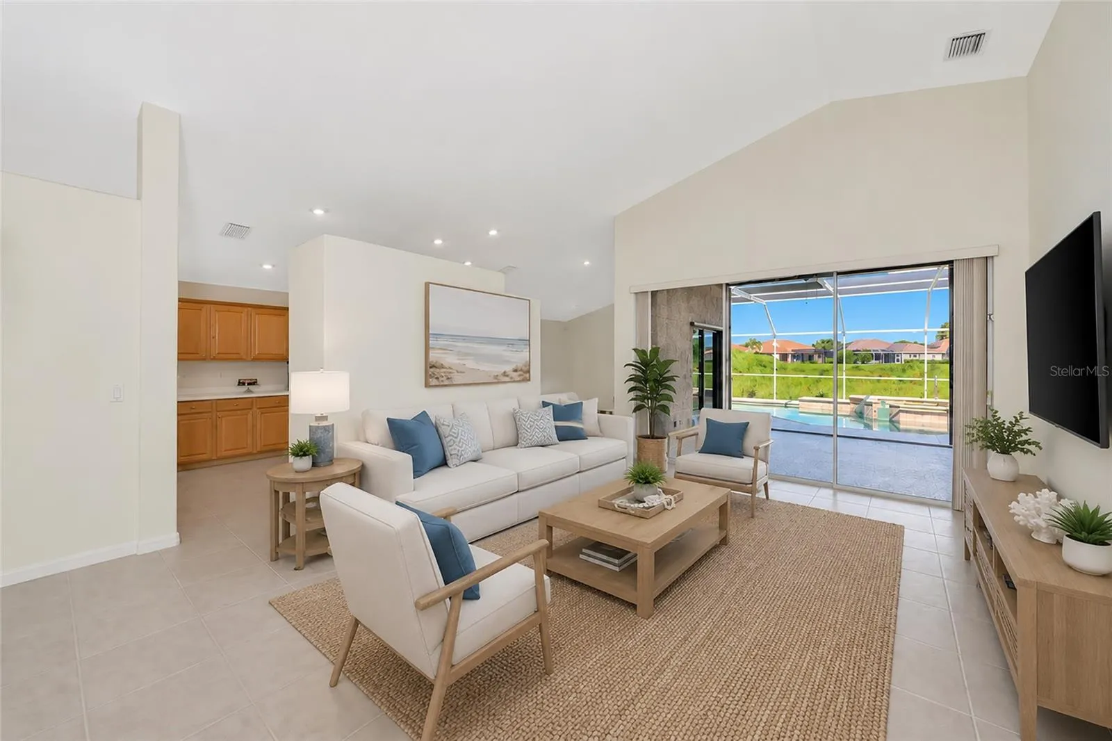 Virtual Staged. Living room view to pool &amp; spa.