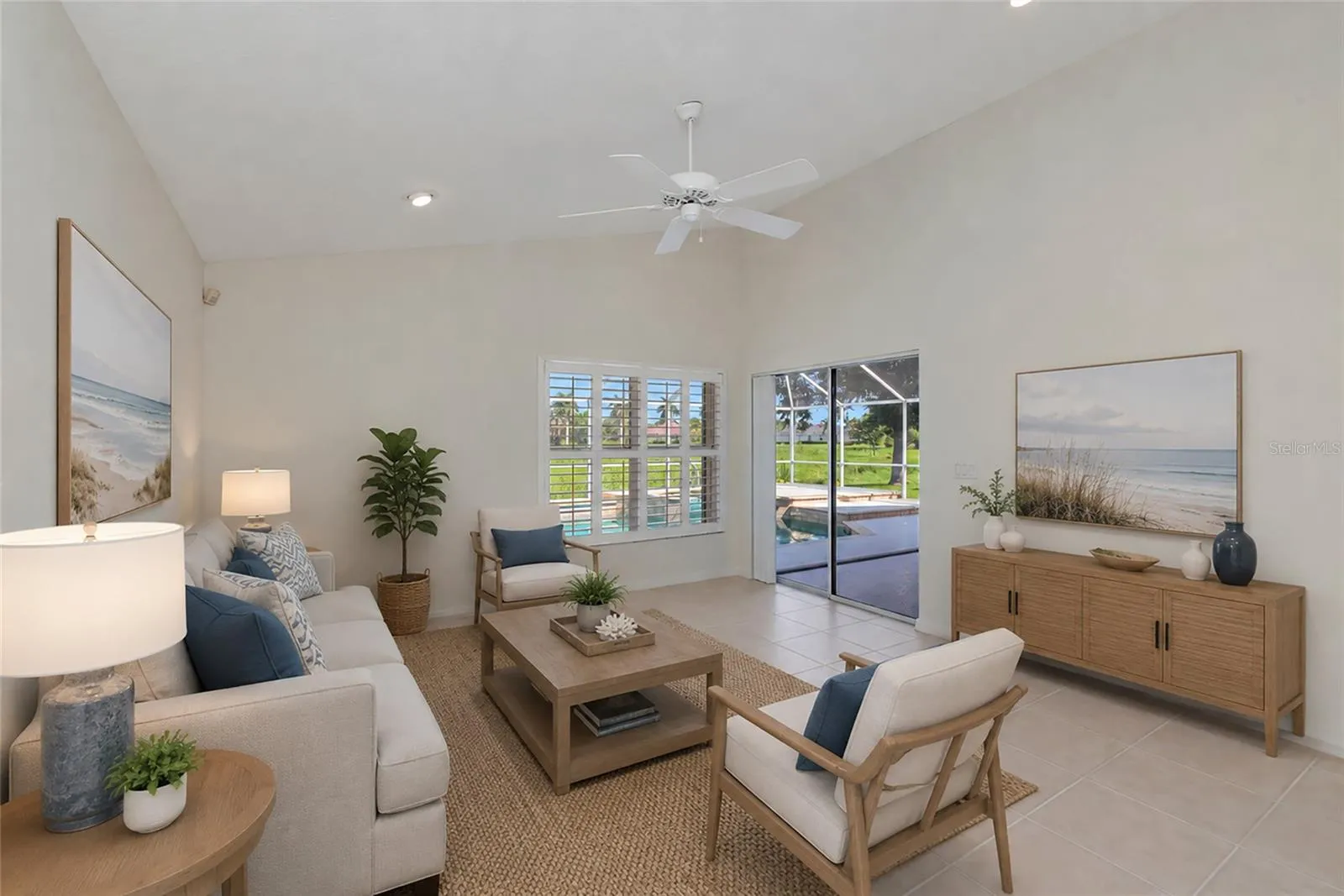 Virtual Staged. Family room open to kitchen with view of pool &amp; spa.