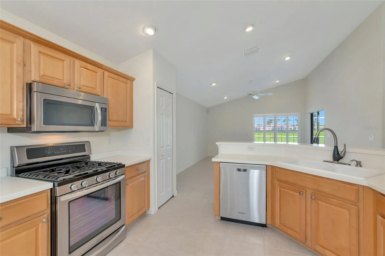 Natura gas range &amp; raised panel maple cabinets.