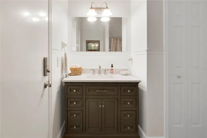 Guest Bathroom with door directly to the pool and lanai with linen closet for pool towels.