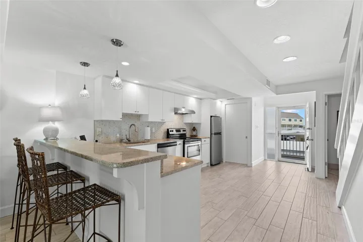 Breakfast bar, kitchen and front door