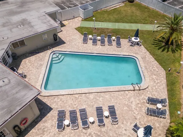 Club house and heated pool area with shuffle board