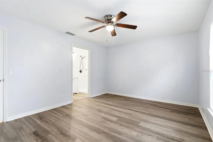 Primary Bedroom, LVP floor, ceiling fan, walk in closet