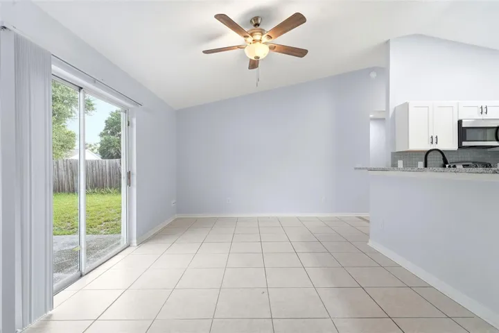 Living room, ceiling fan and tile floors, sliding glass doors