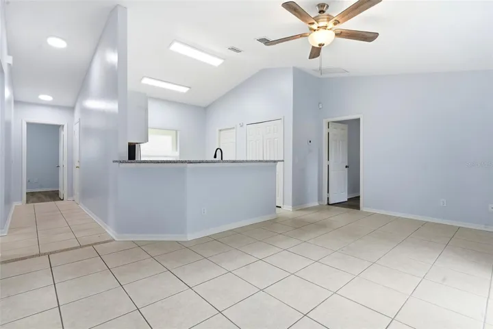 Living room, ceiling fan and tile floors