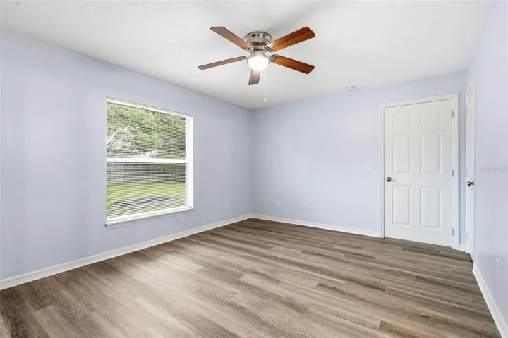 Primary Bedroom, LVP floor, ceiling fan, walk in closet