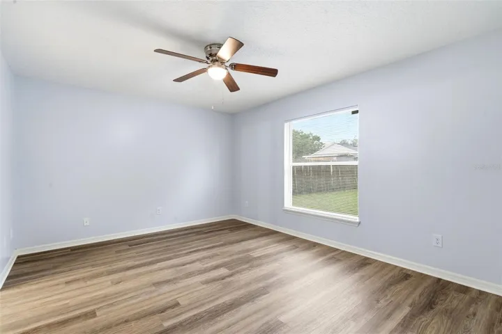 Primary Bedroom, LVP floor, ceiling fan, walk in closet