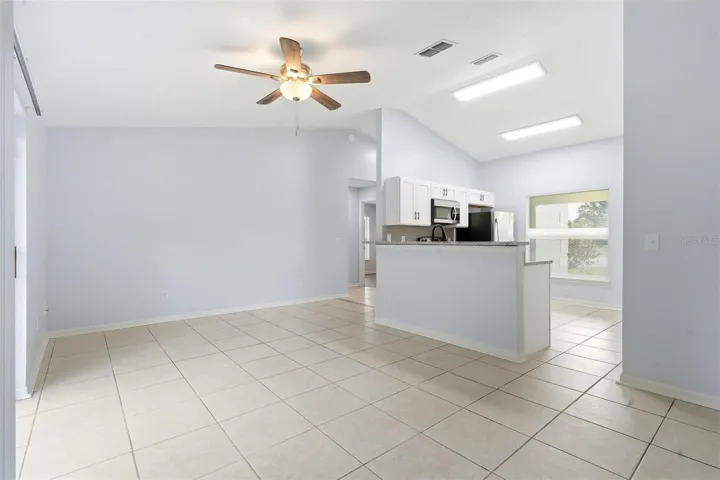 Living room, ceiling fan and tile floors, sliding glass doors
