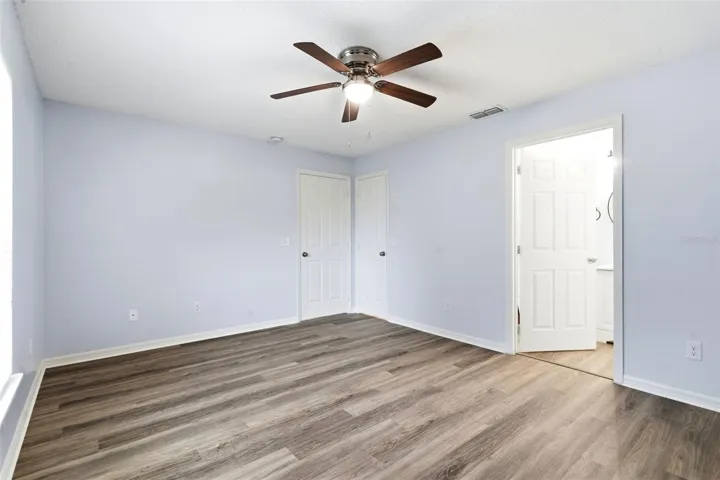 Primary Bedroom, LVP floor, ceiling fan, walk in closet
