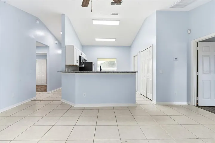 Living room, ceiling fan and tile floors