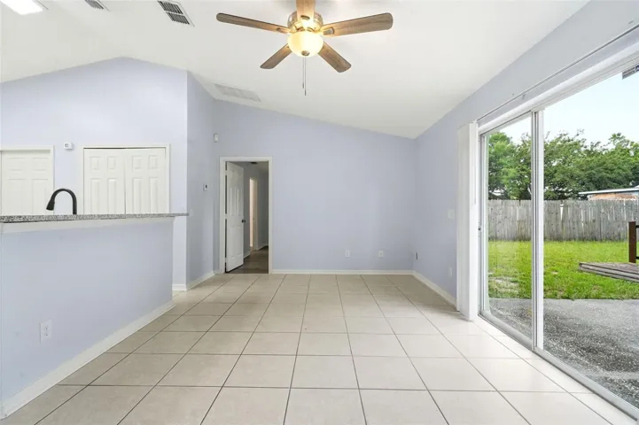 Living room, ceiling fan and tile floors, sliding glass doors