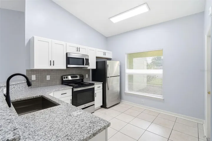 Renovated kitchen, granite counter tops, stainless steel appliances, New cabinets, tile floor