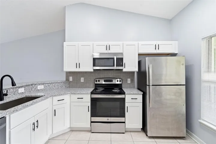 Renovated kitchen, granite counter tops, stainless steel appliances, New cabinets, tile floor