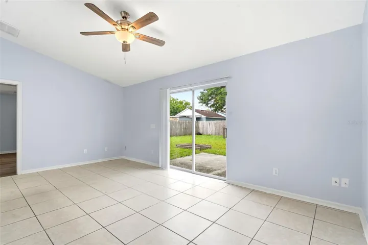 Living room, ceiling fan and tile floors, sliding glass doors