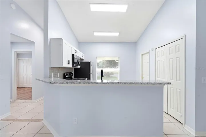 Living room, ceiling fan and tile floors