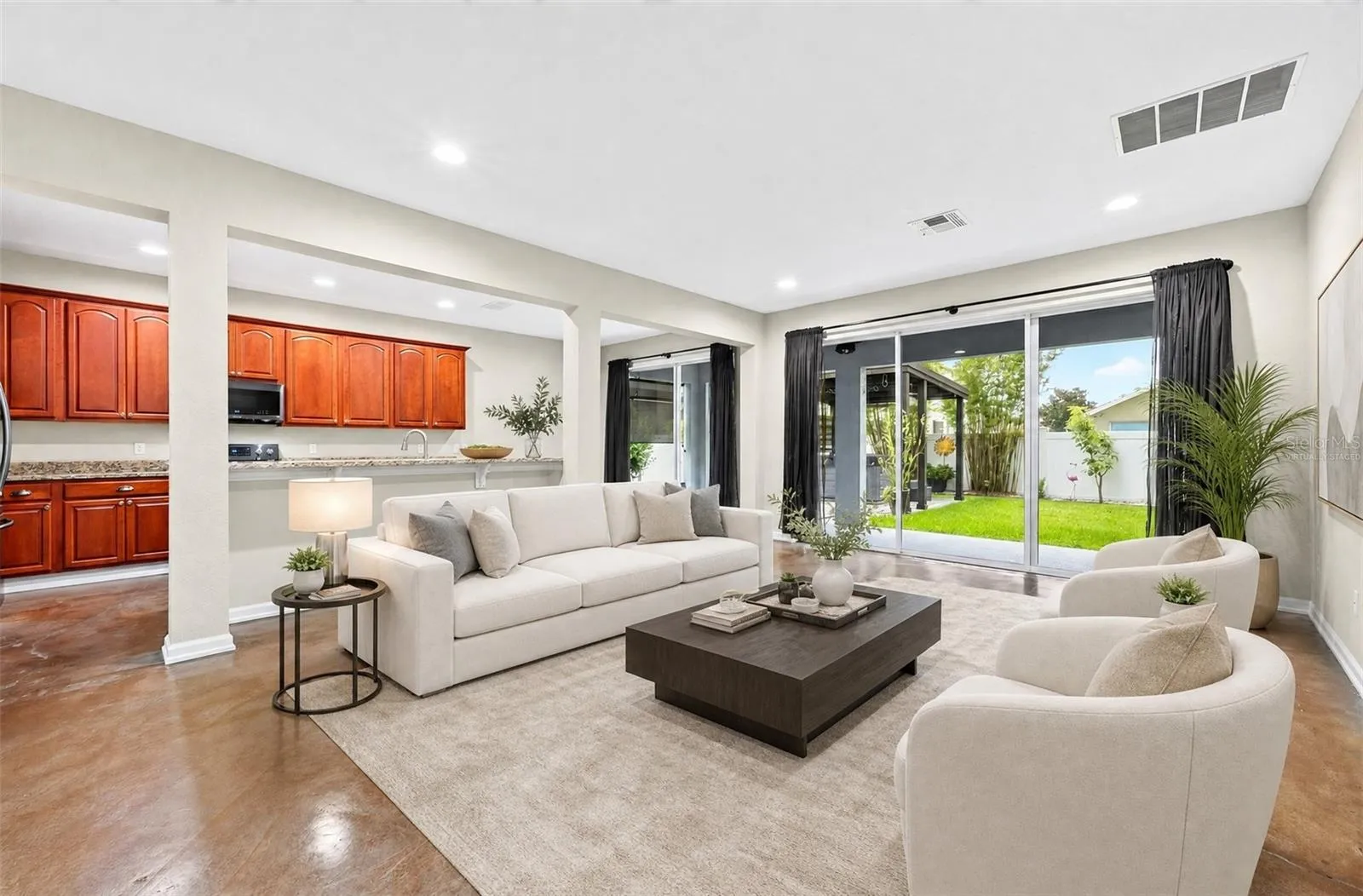 Open living area with a wall of sliding glass doors for the ultimate in indoor/outdoor living. Virtually Staged.