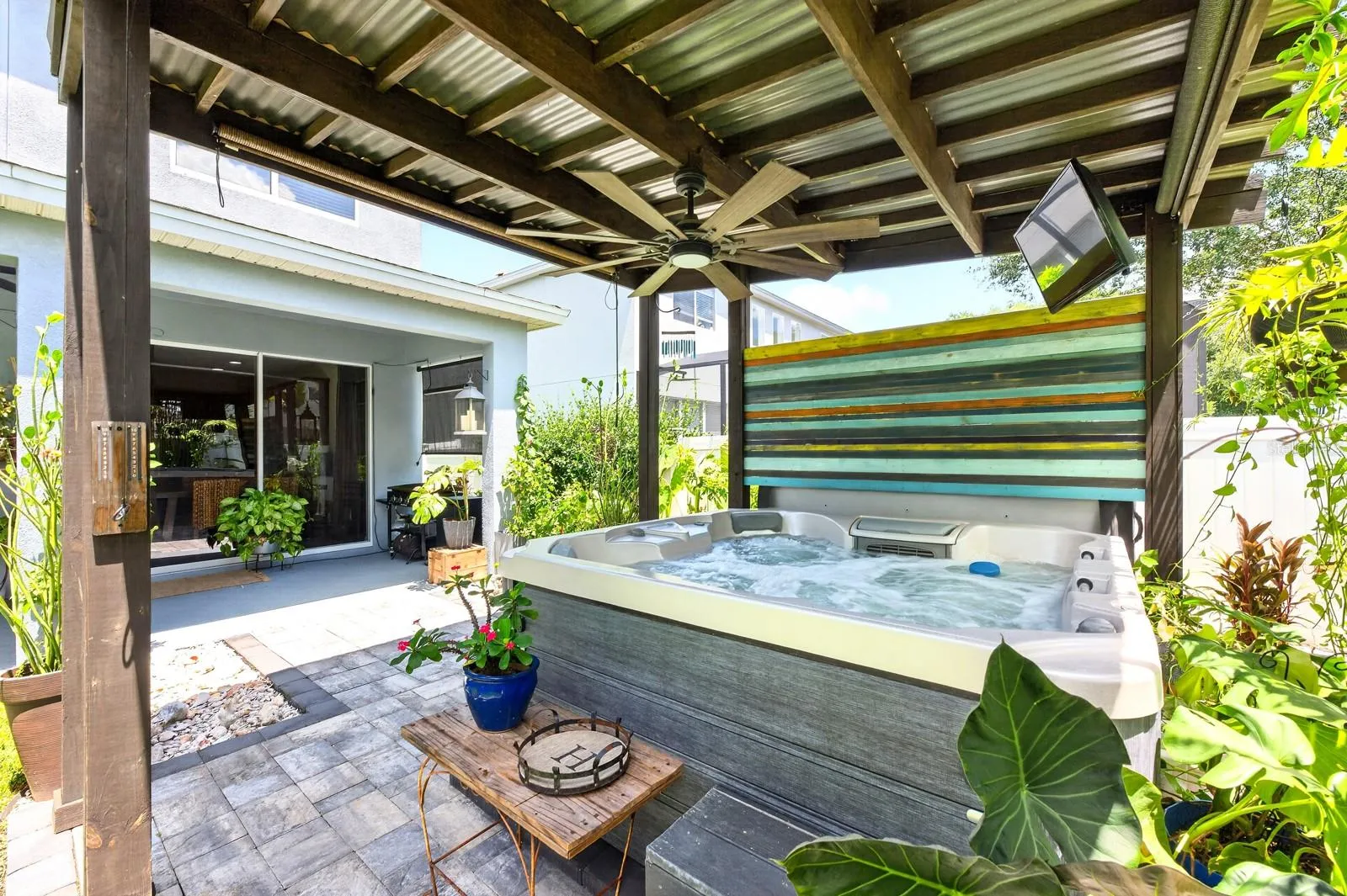 Covered spa surrounded by a paver patio to relax and unwind.