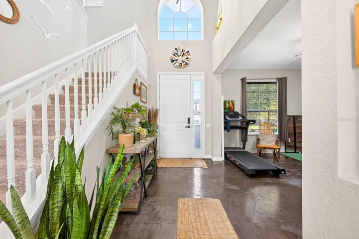 Two story foyer pulls in the natural light.