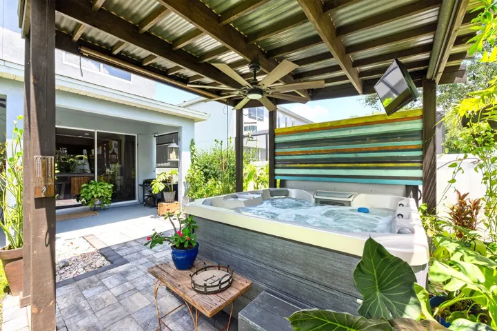 Covered spa surrounded by a paver patio to relax and unwind.
