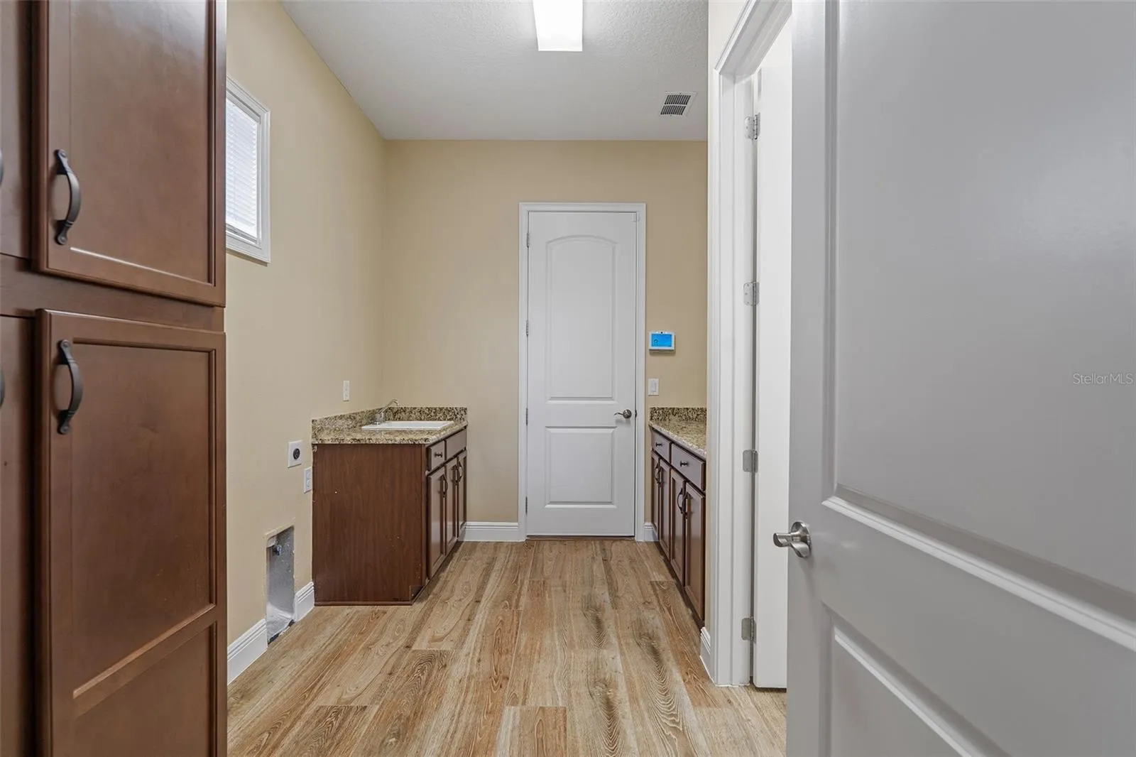Oversized laundry room leads to garage