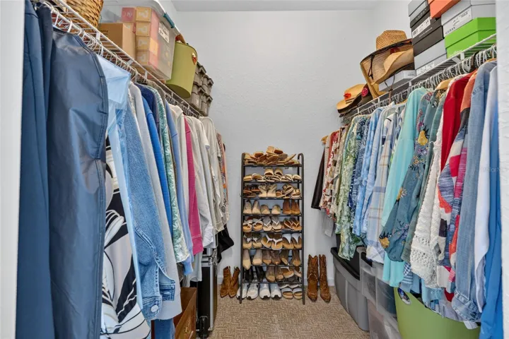 1 of 2 walk in closets in primary bedroom
