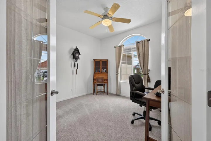 Double doors to den or office. Armoire can convey and could then be used as a bedroom.