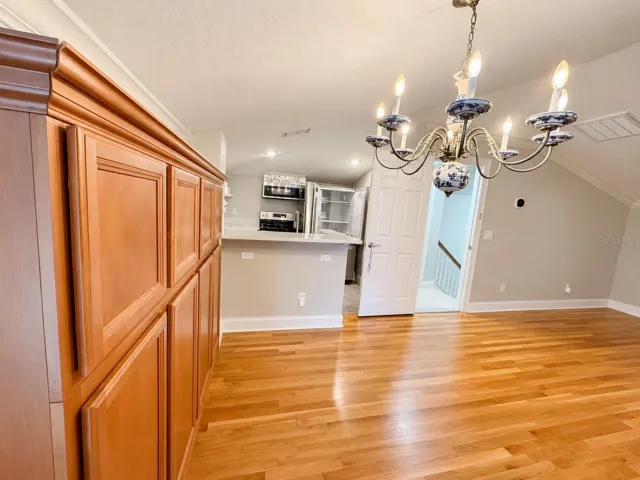 A fully renovated 1 bedroom apartment above the garage offers its own private covered entrance &amp; full kitchen, w/ new luxury vinyl flooring, quartz counters &amp; stainless steel appliances. The living room &amp; bedroom feature hardwood flooring &amp; crown molding. The entry closet has been upgraded w/ a water hookup for a washer &amp; dryer (not included), a new water heater &amp; the apartment has its own central vacuum.