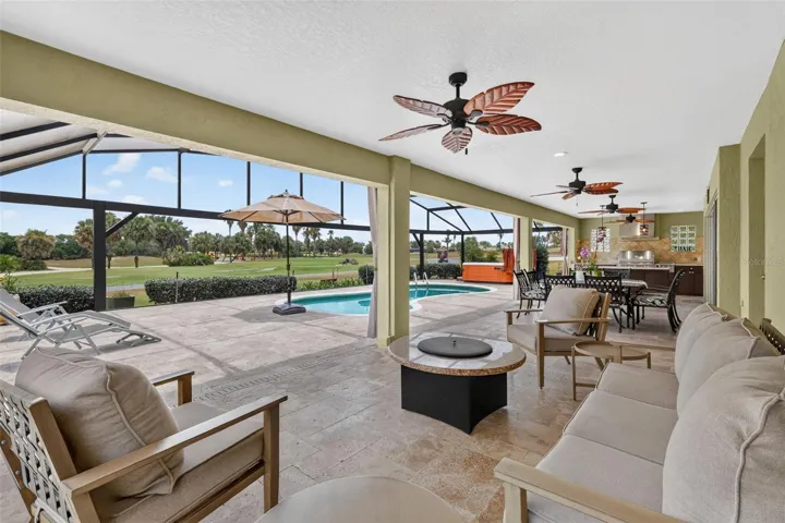 Swimming Pool, Hot Tub, Lanai, and Outdoor Kitchen with Golf Front Views