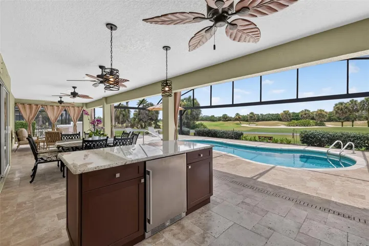 Swimming Pool, Lanai, and Outdoor Kitchen with Golf Front Views
