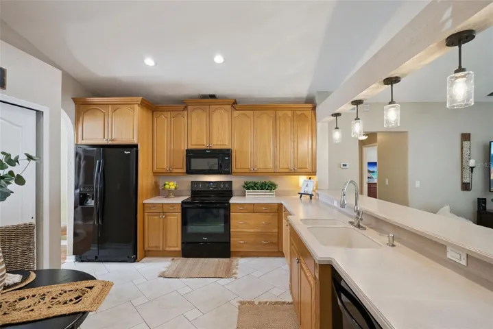 UPDATED KITCHEN featuring NEWER APPLIANCES, WOOD CABINETRY, a BUILT-IN PANTRY, BREAKFAST BAR, and a DINETTE AREA