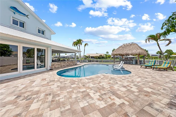 Plenty of brick paver pool deck entertaining area.