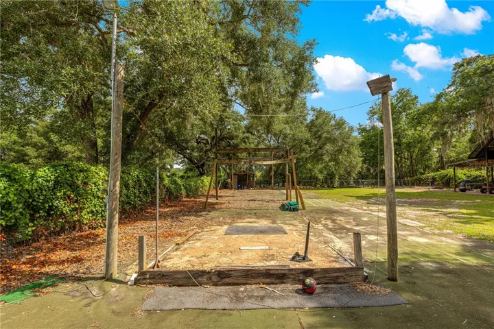 This was a battng cage.  Pole have been removed so area can be used as you wish.  There in a fish cleaning station and small tool or fishing equipment storage covered area toward the canal.